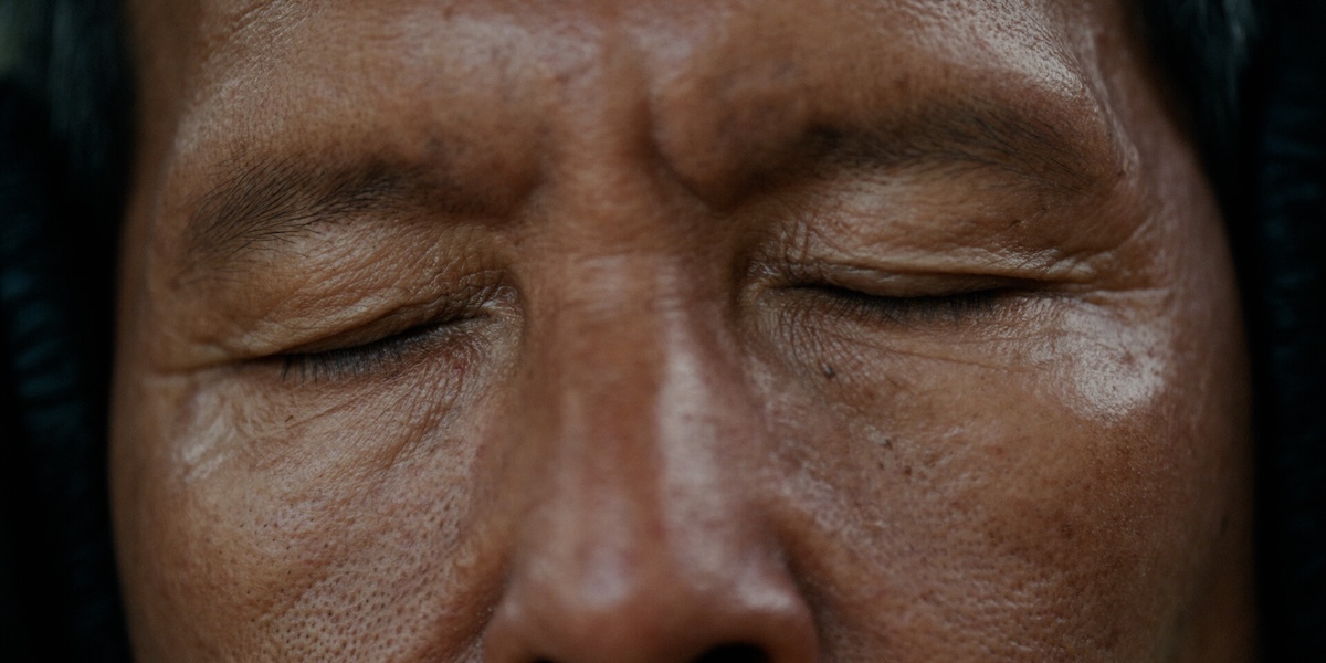 Close up of person with eyes closed.