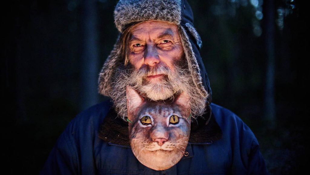 Man with cat in coat