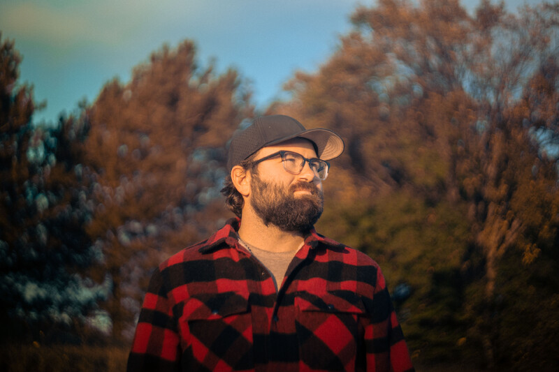 Person with beard and flannel shirt