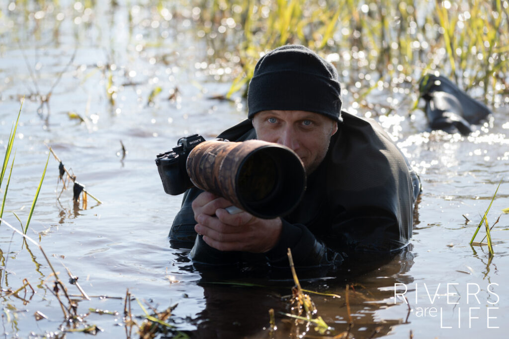 Person in marsh with camera