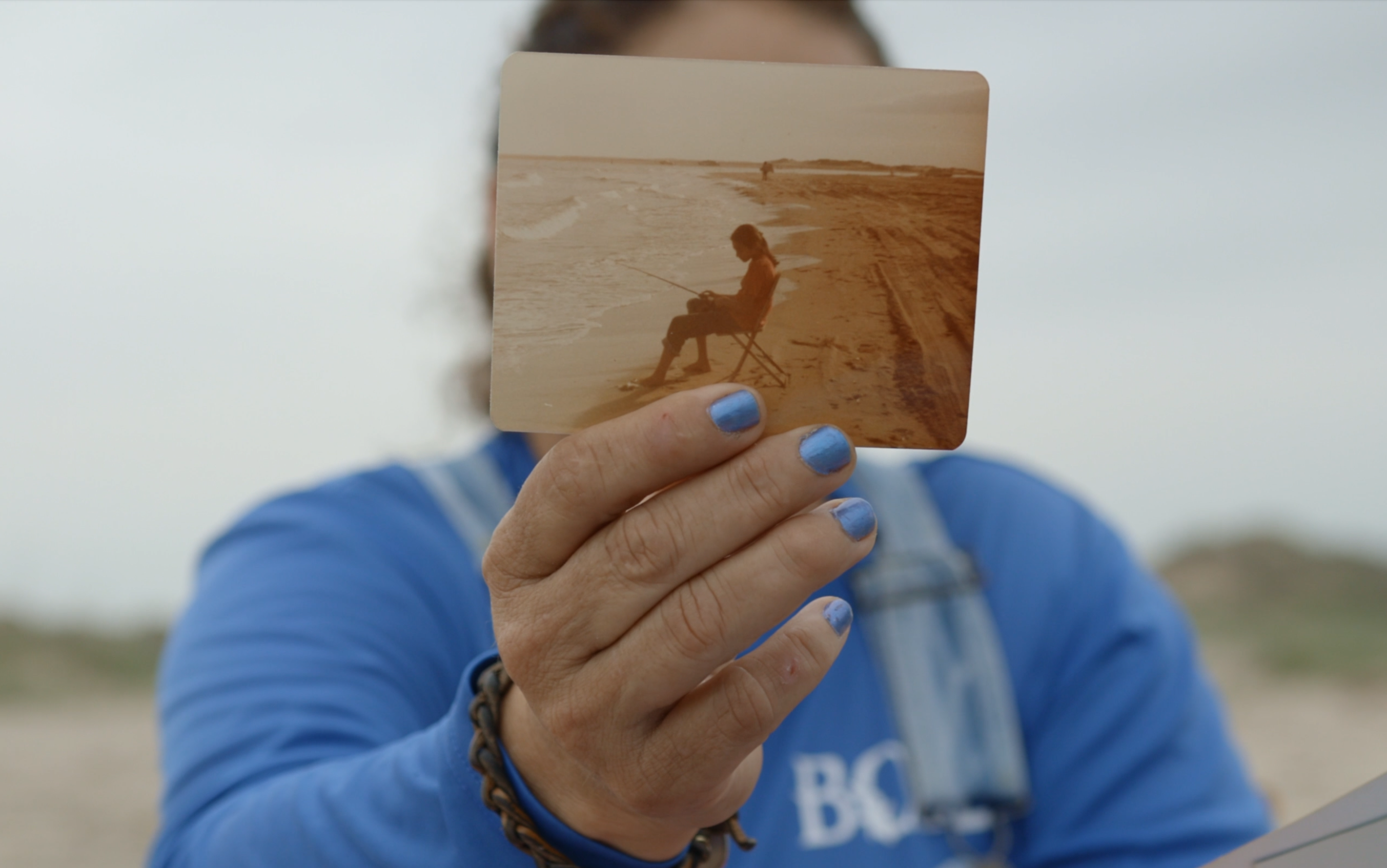 Boca Chica IWFF-2 Person holds sepia toned photo in front of face.
