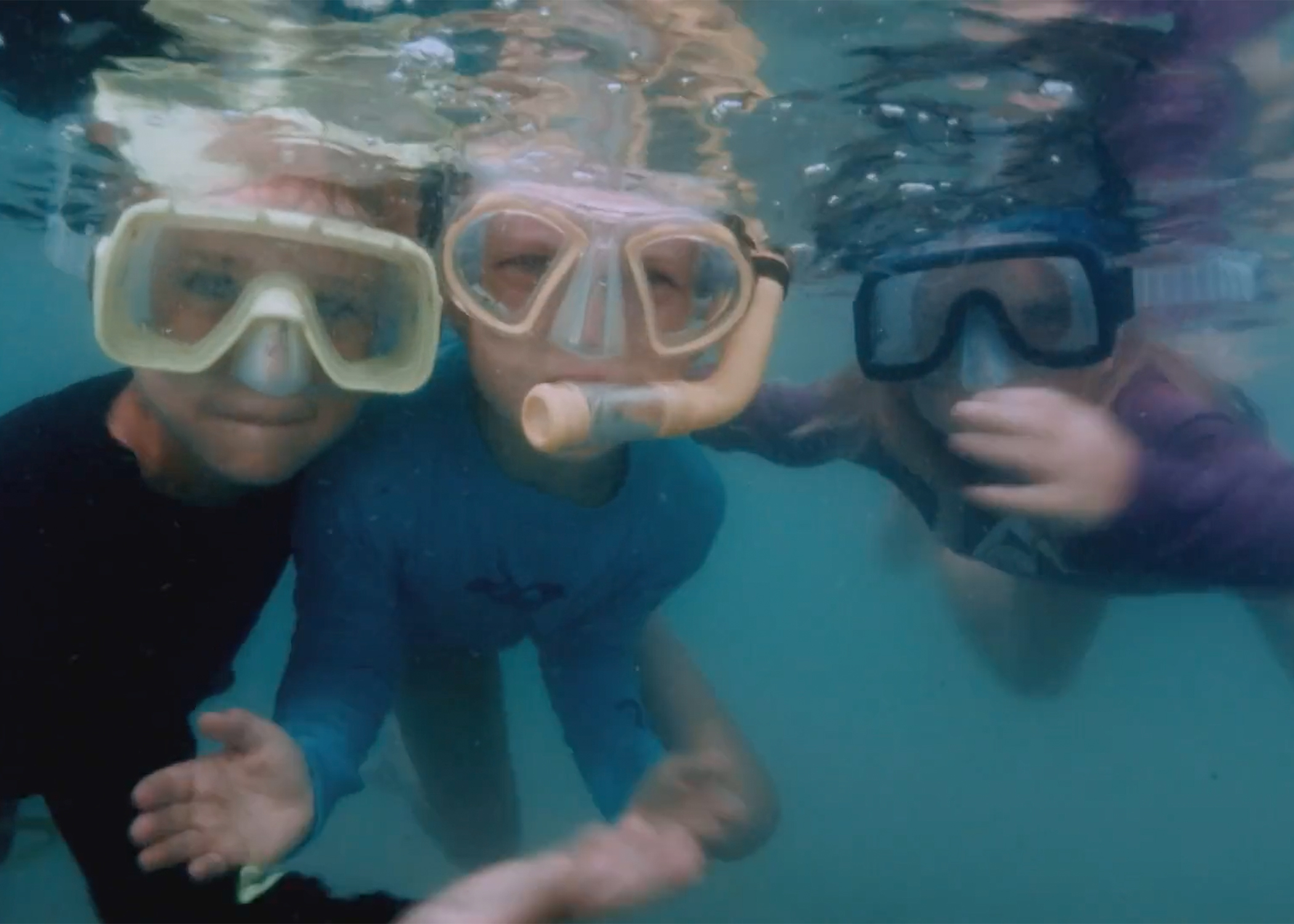 Kids swimming Group of kids with googles underwater.