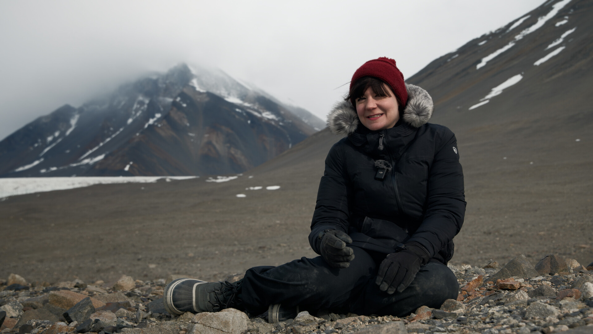 Person sitting in front of mountains.