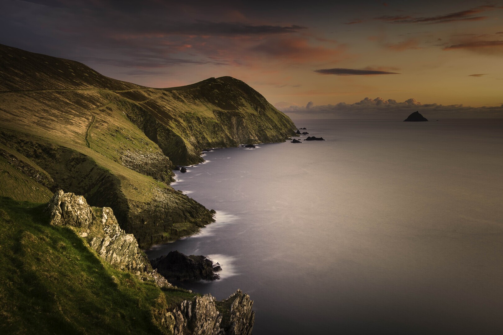 Sunset or sunrise on cliffs by sea.