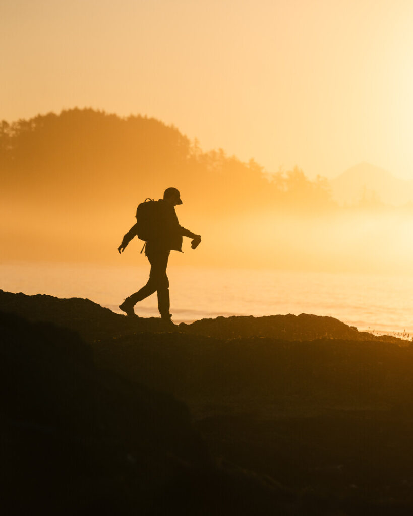 Person walks on low light beach.