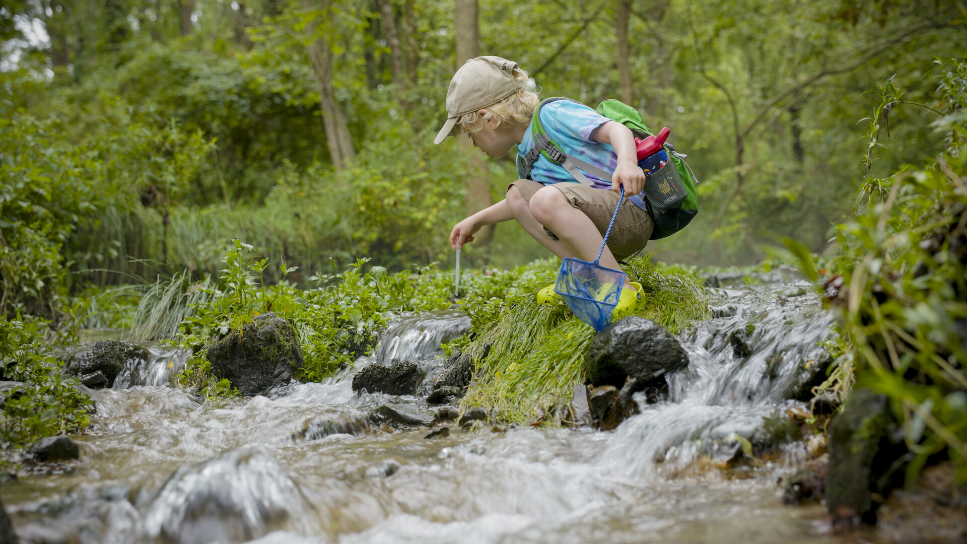 img-6780350387ce7 Child standing in stream.