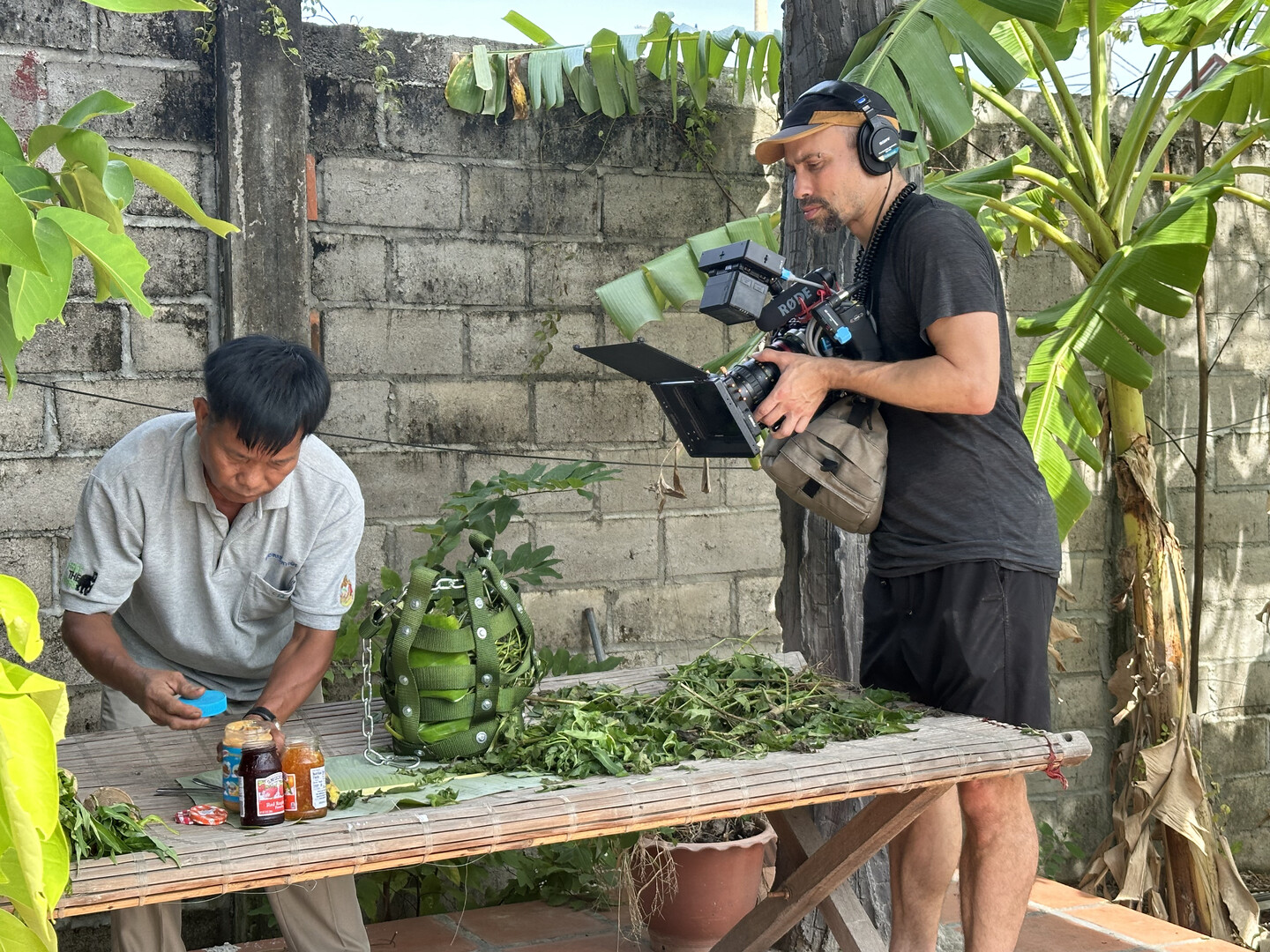 Person filming another person with camera.