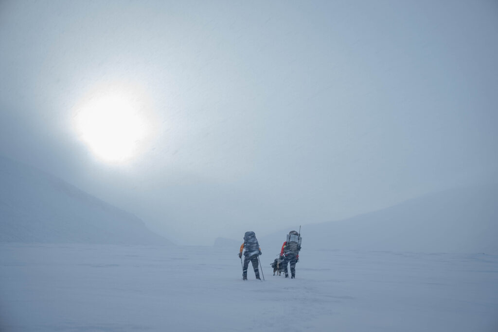 Two people in snowy landscape.