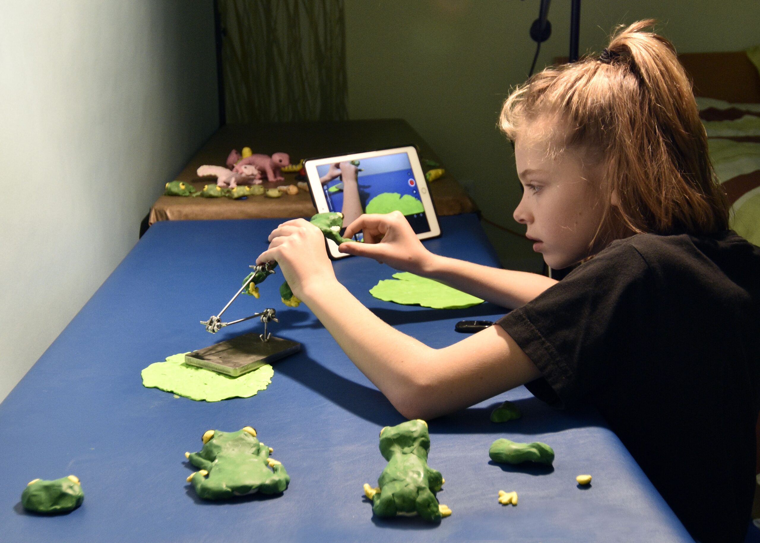 Kid setting up stop motion display.
