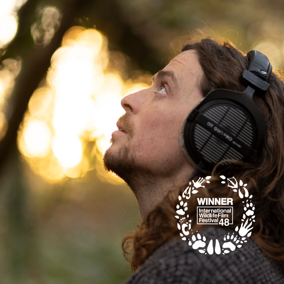 Person looks up wearing headphones.