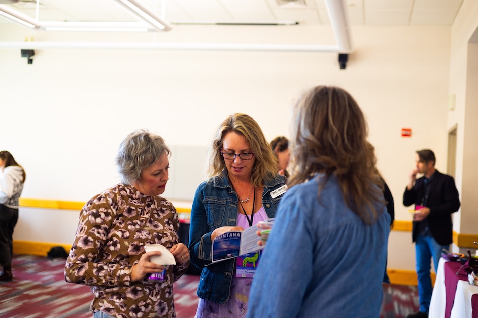 Group of people look at program inside.