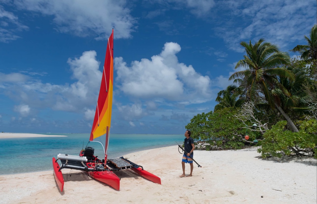 Boat and person on beach.