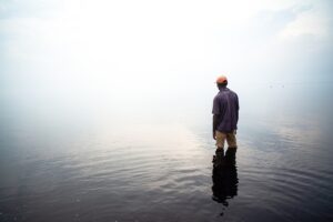 Person stands in water.