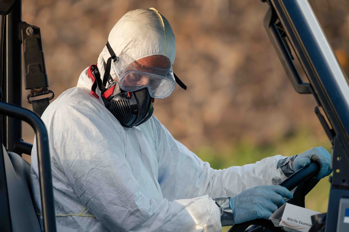 Person in protective gear looks to the side.