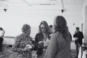 Three people look at program.