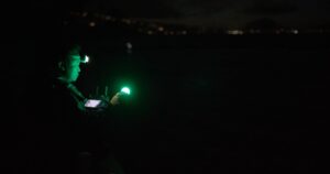 Person in dark with headlamp.