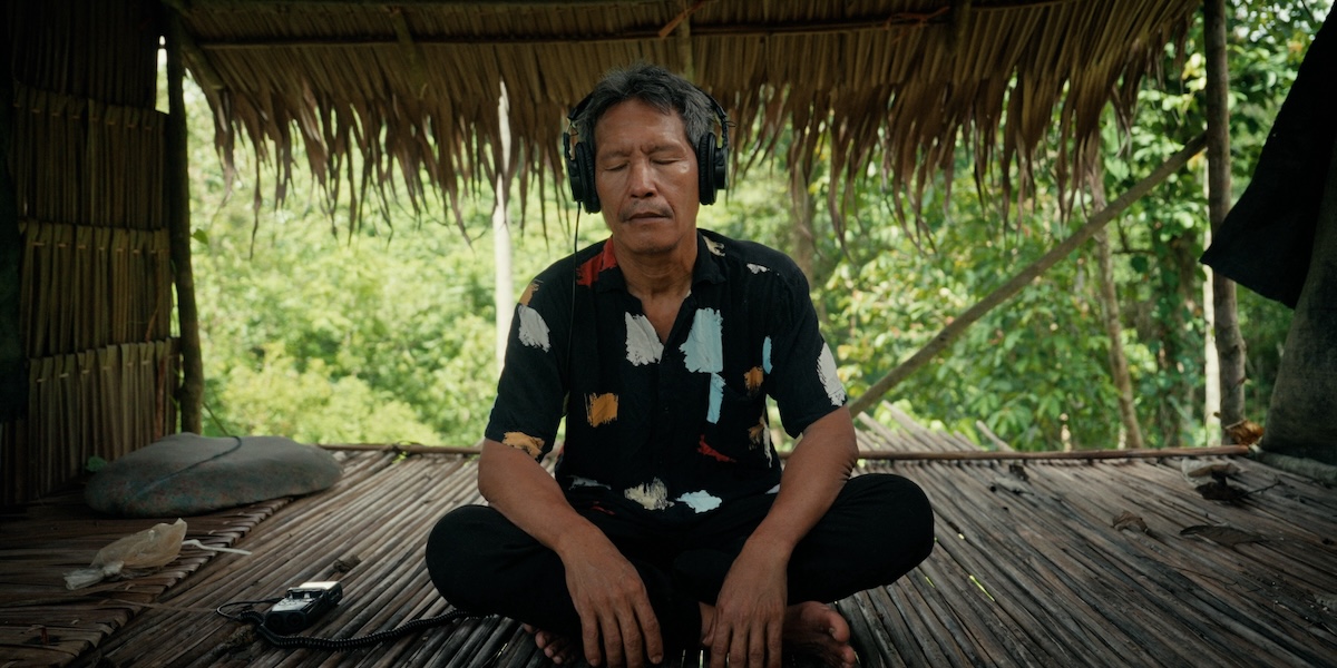 Person sitting with headphones on.