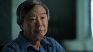 Person sitting looking forward.